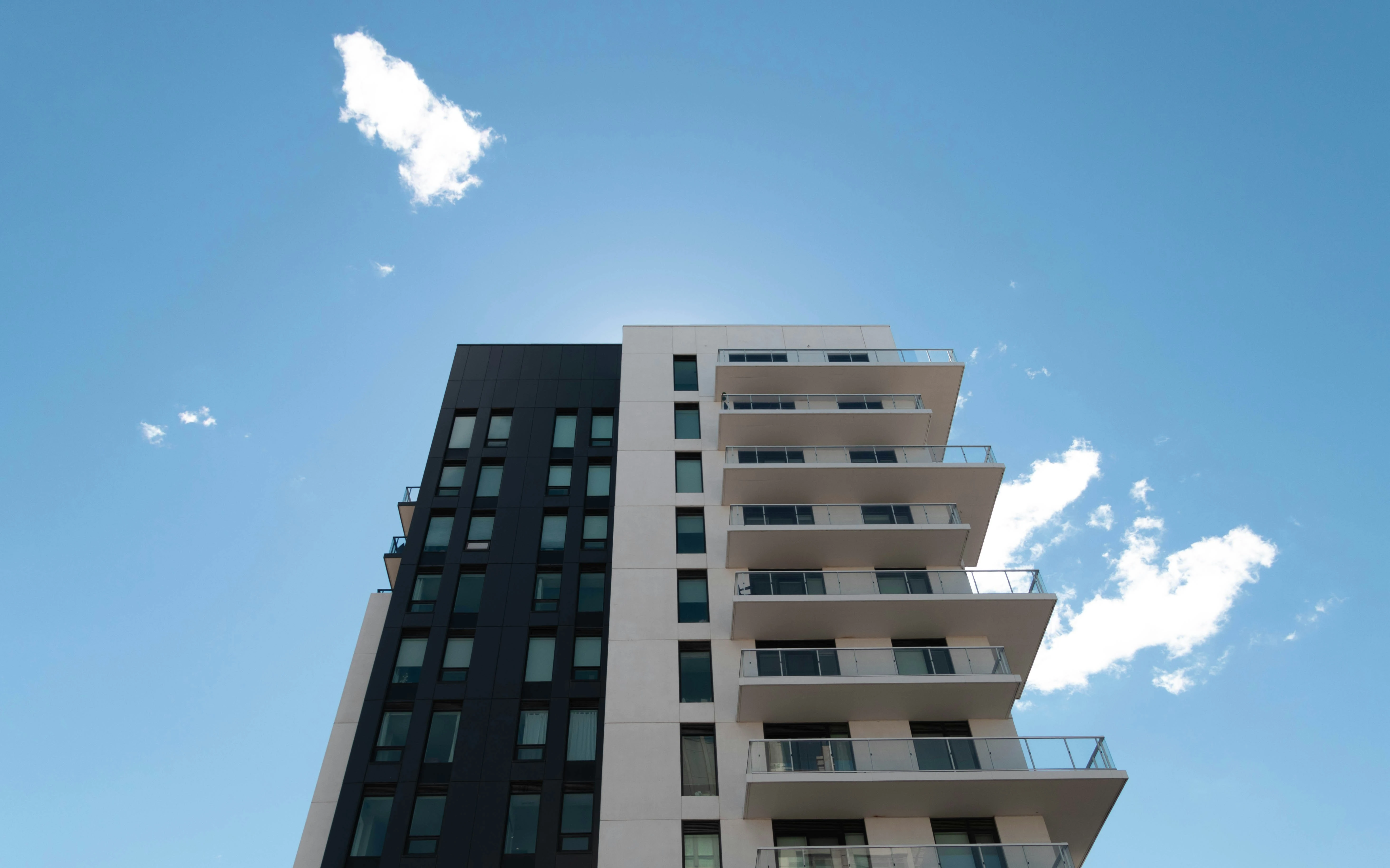 A photograph of a black and white condo building in Markham, Ontario